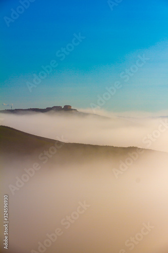 Crete Senesi landscape in Tuscany, Italy on a foggy dawn