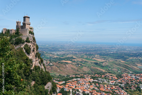 The fortress, first tower, at the foot of the mountain city. Summer sunny day. Pass of the witches. vertical photo Fortification on top of the mountain, old castle. San Marino, Italy