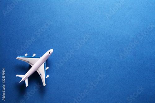 toy passenger plane on a blue background, top view with place for your text