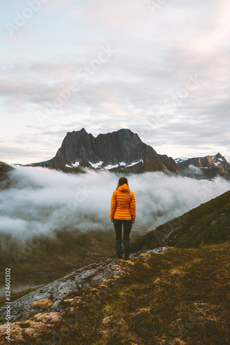 Woman standing alone in mountains travel adventure lifestyle outdoor in Norway hiking activity recreation motivation concept