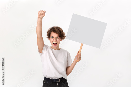 Concerned female protester holding empty signboard with copy space. photo