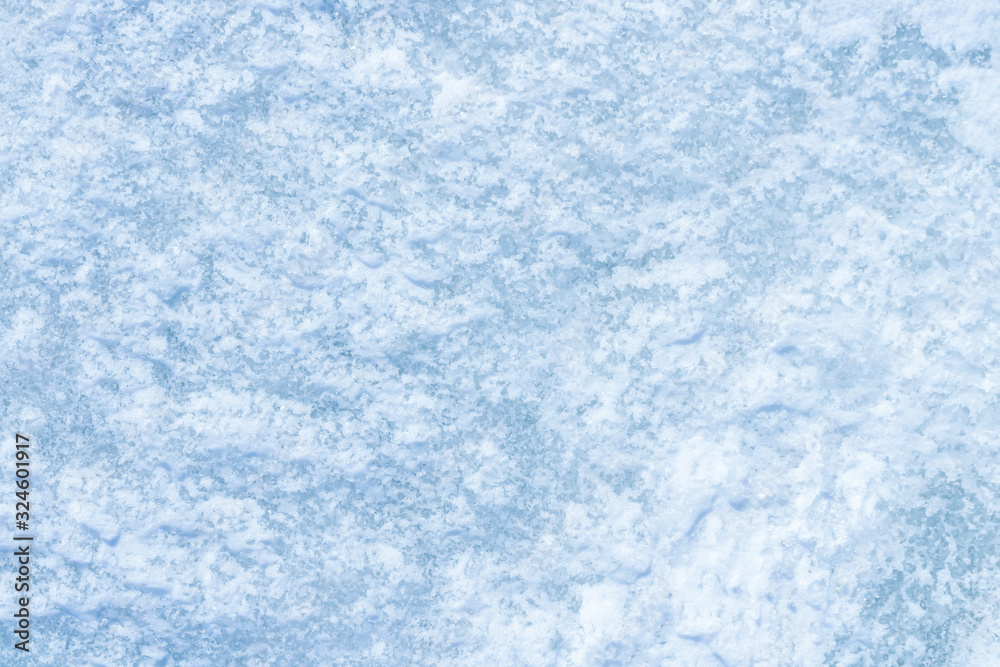 blue texture of an snow surface with pure white wave , blue cold clear cryslallized wall background ,winter frozen lake side close up , abstract macro wallpaper