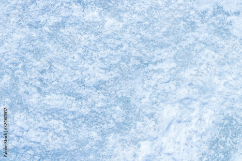 blue texture of an snow surface with pure white wave , blue cold clear cryslallized wall background ,winter frozen lake side close up , abstract macro wallpaper