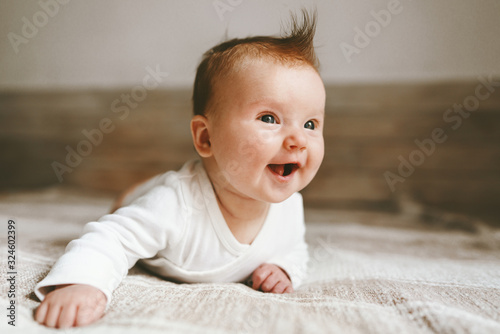 Fotografie, Obraz Smiling baby infant crawling at home adorable child portrait family lifestyle 3