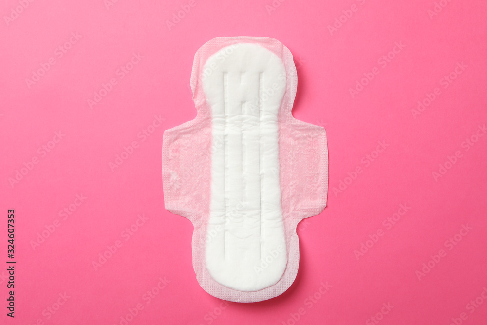 Sanitary pad on pink background, top view Sanitary pad on pink background, top view