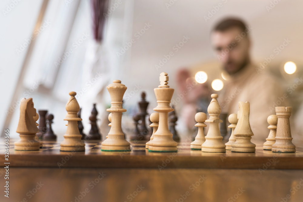 Black and white chess figures on a chessboard, closeup. Set of chess figures on the playing board Black and white chess figures on a chessboard, closeup. Set of chess figures on the playing board