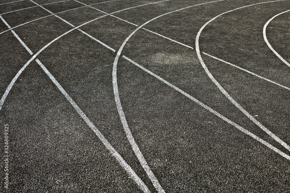 Intersecting athletic lines on a grey background with no people