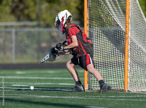 Young athletes making amazing plays while playing in a Lacrosse game photo