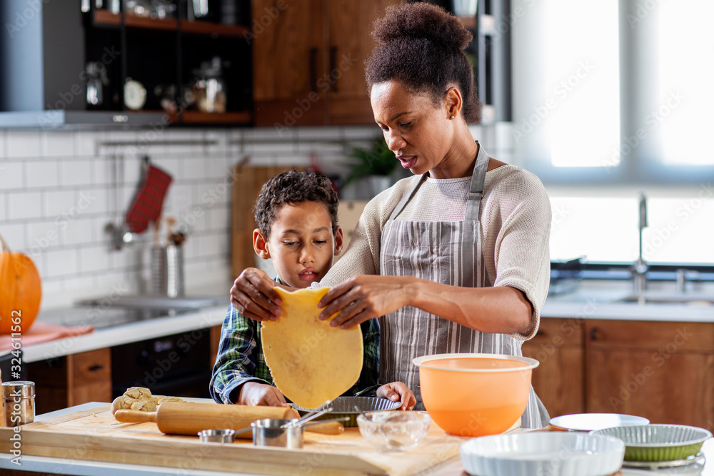 Mother with his son prepare pie in the kitchen Mother with his son prepare pie in the kitchen