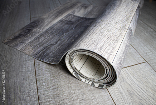 Roll of linoleum with a wood texture. Linoleum cutting. Floor coverings. photo