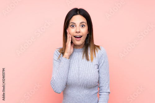 Woman over isolated pink background with surprise and shocked facial expression © luismolinero