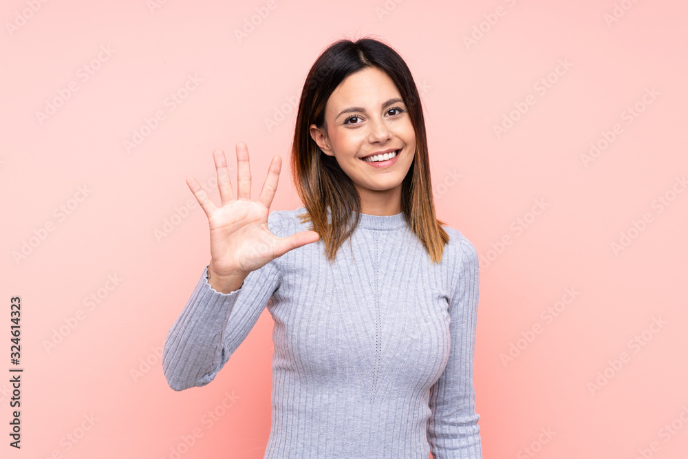 Woman over isolated pink background counting five with fingers Woman over isolated pink background counting five with fingers
