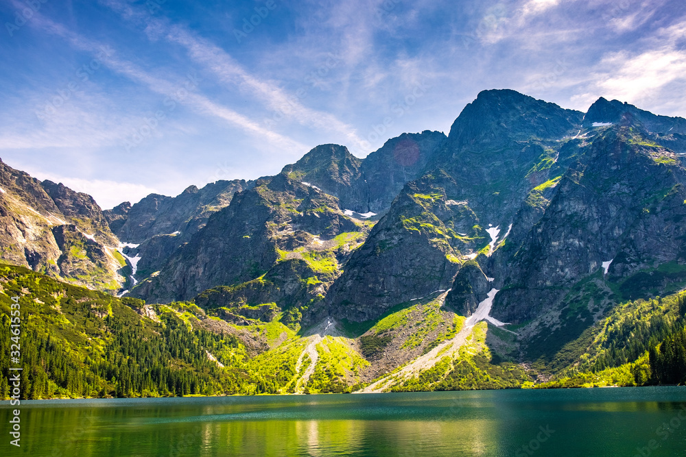 Plakat Panoramic view of Morskie Oko lake with Tatra Mountains peaks - Zabia Turnia, Wolowy Grzbiet, Kazalnica, Rysy, Mieguszowieckie Szczyty and Czarny Staw pod Rysami, Black Pond at Rysy - in background