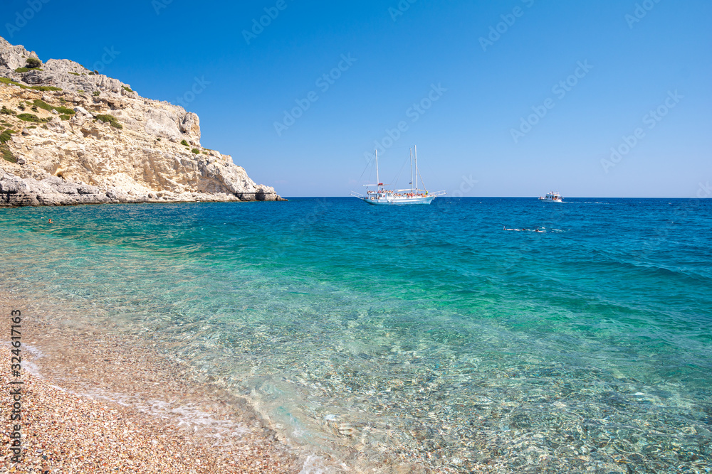 crystal clear water of mediterranean sea on Afandou beach on Rhodes island in Greece