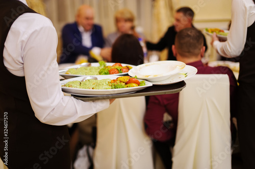 waiter with plate with food in the hands