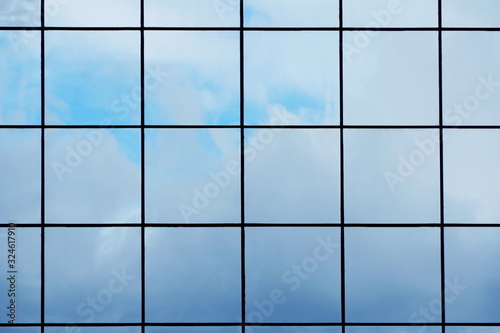 Glass with mirror effect in frames, facing of a modern office building