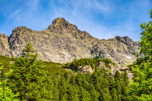 Lower Rysy - Niznie Rysy - and Rysy peaks rising above Czarny Staw pod Rysami, Black Pond below Rysy, in Tatra Mountains in Poland photo