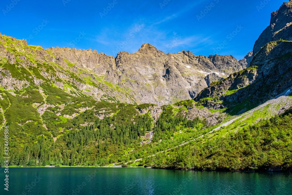 Lower Rysy - Niznie Rysy - and Rysy peaks rising above Czarny Staw pod Rysami and Morskie Oko lakes in Tatra Mountains in Poland