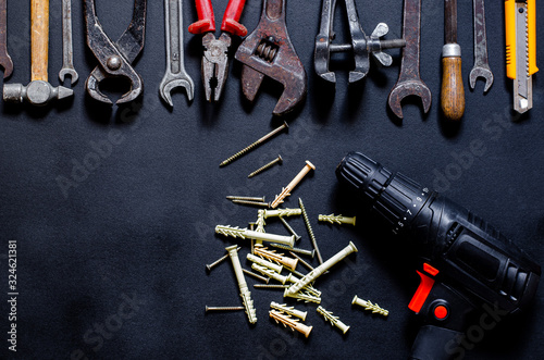 Construction worker tools on a dark background top view.
