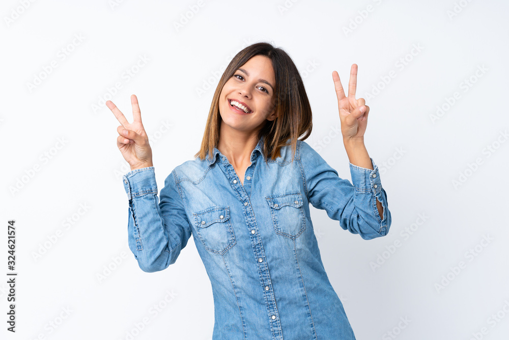 Young woman over isolated white background showing victory sign with both hands Young woman over isolated white background showing victory sign with both hands