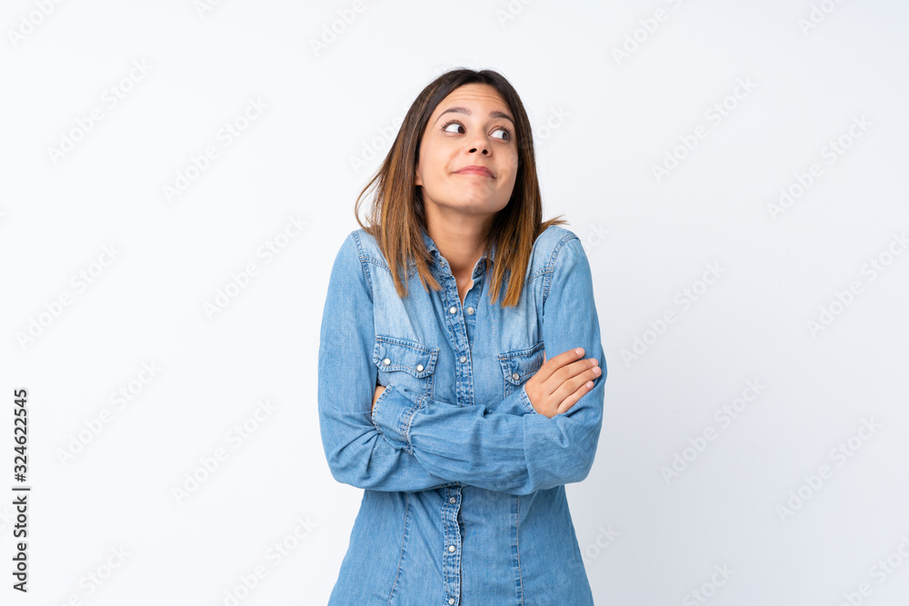 Young woman over isolated white background making doubts gesture while lifting the shoulders Young woman over isolated white background making doubts gesture while lifting the shoulders