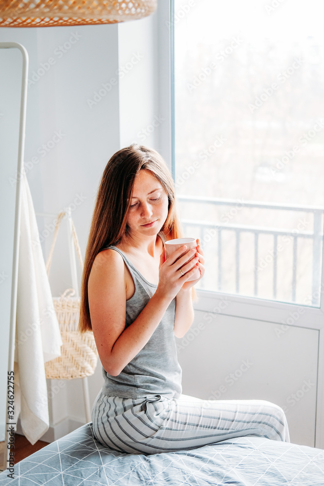 Getting ready. Young woman at her bedroom in the early morning. Getting ready. Young woman at her bedroom in the early morning.