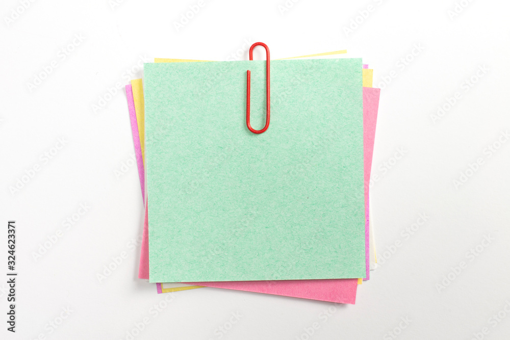 Colorful note paper pin with red paper clips and isolated on white. Colorful note paper pin with red paper clips and isolated on white.