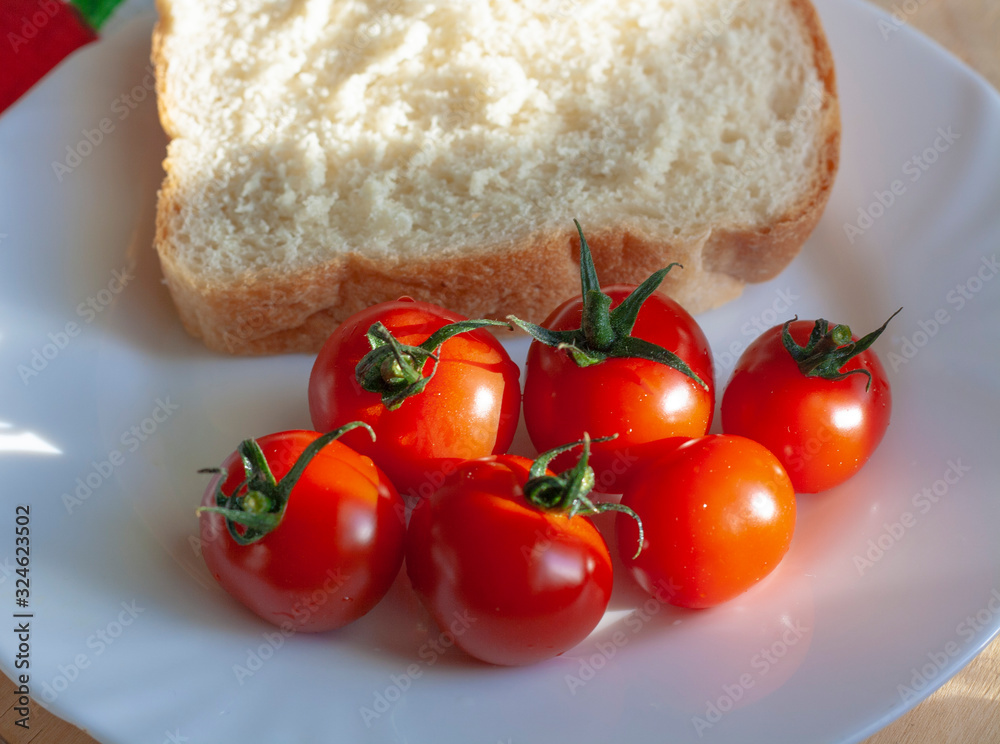 Cherry tomatoes and a slice of toast bread Cherry tomatoes and a slice of toast bread