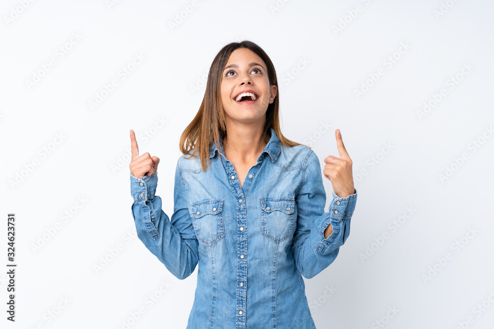 Young woman over isolated white background surprised and pointing up