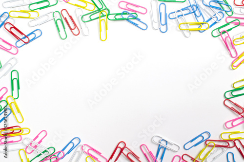 Colorful paper clips isolated on white with free space in the centre.
