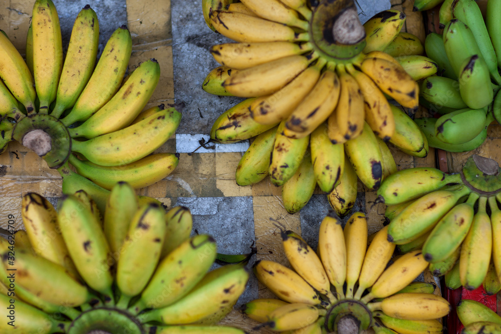Yellow and green bananas top view on the market in Asia. Yellow and green bananas top view on the market in Asia.