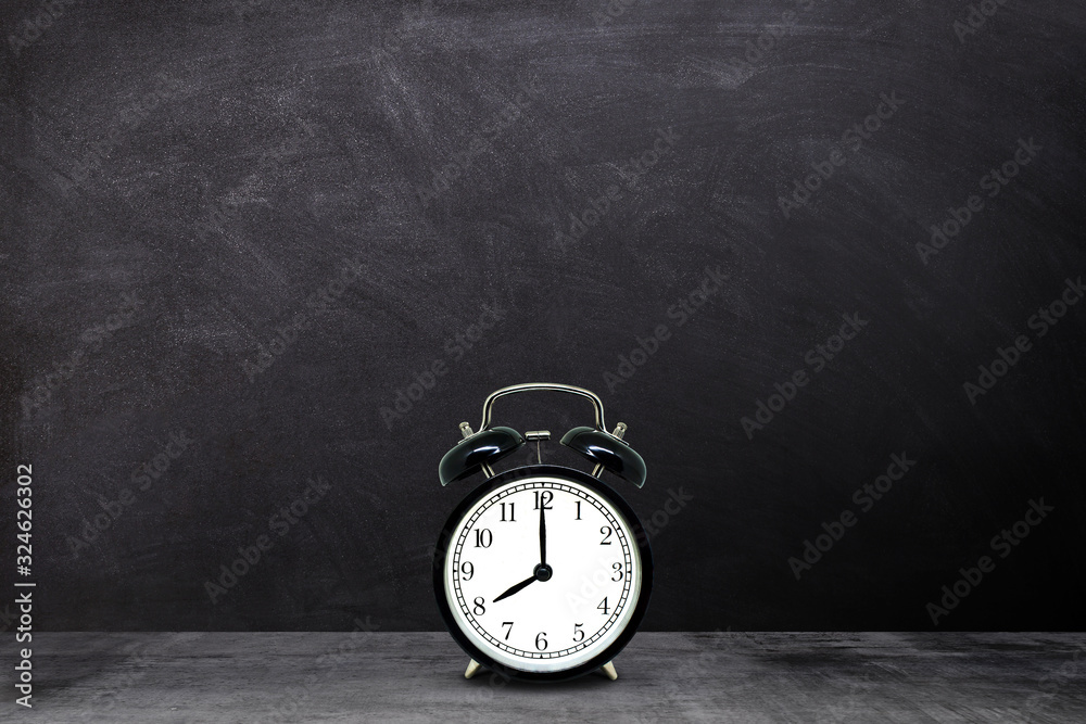 Time Management Concept : Retro black alarm clock showing eight o'clock with chalkboard background. Time Management Concept : Retro black alarm clock showing eight o'clock with chalkboard background.