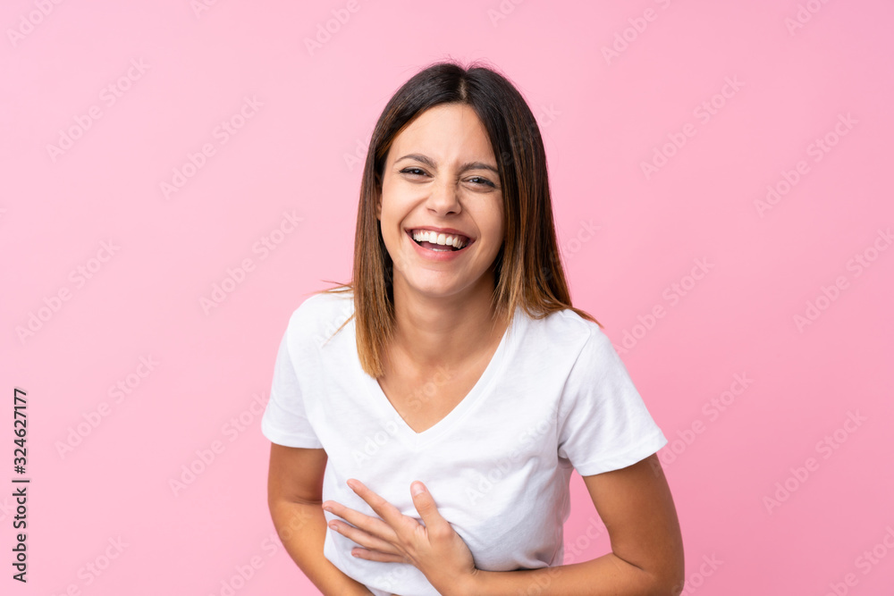 Young woman over isolated pink background smiling a lot Young woman over isolated pink background smiling a lot