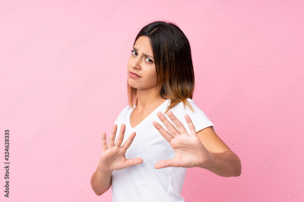 Young woman over isolated pink background nervous stretching hands to the front Young woman over isolated pink background nervous stretching hands to the front