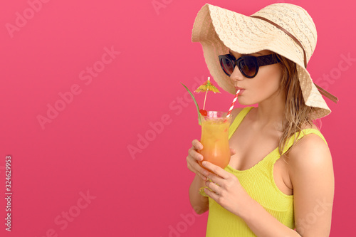 Young woman drinking a tropical cocktail