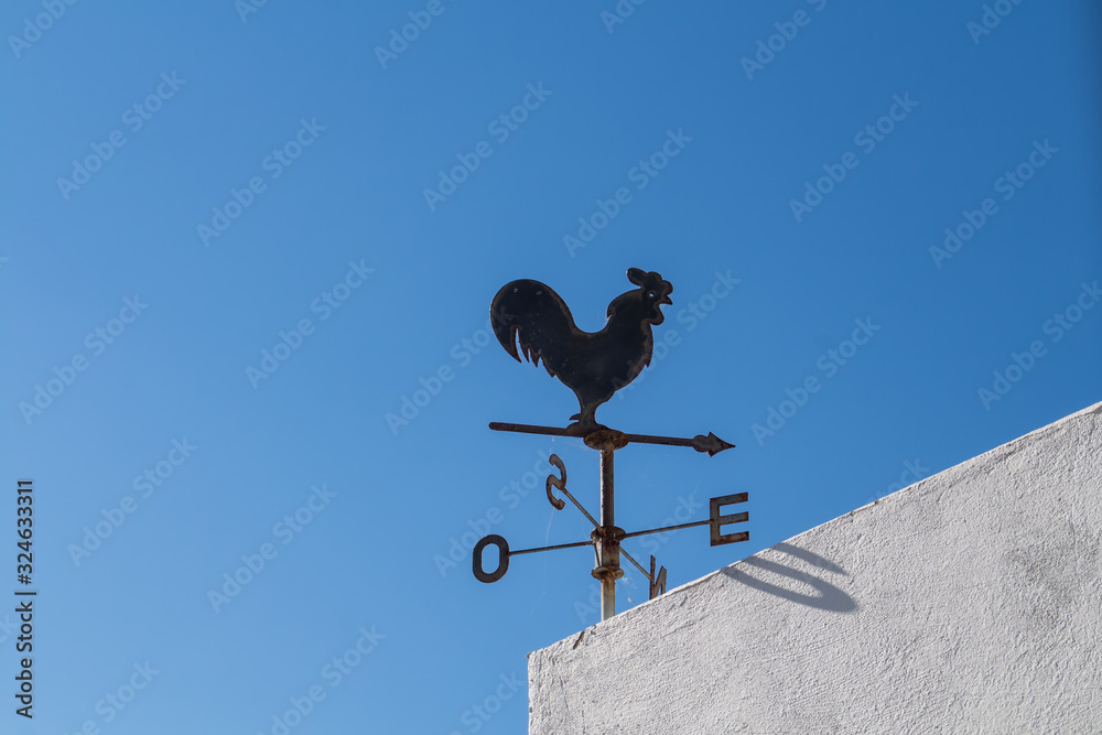 Rooster with compass on a building Rooster with compass on a building