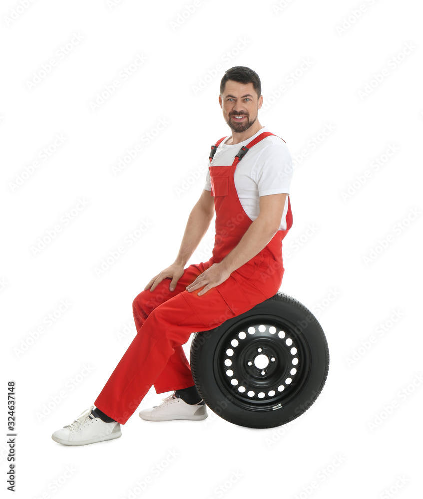 Full length portrait of professional auto mechanic with wheel on white background Full length portrait of professional auto mechanic with wheel on white background