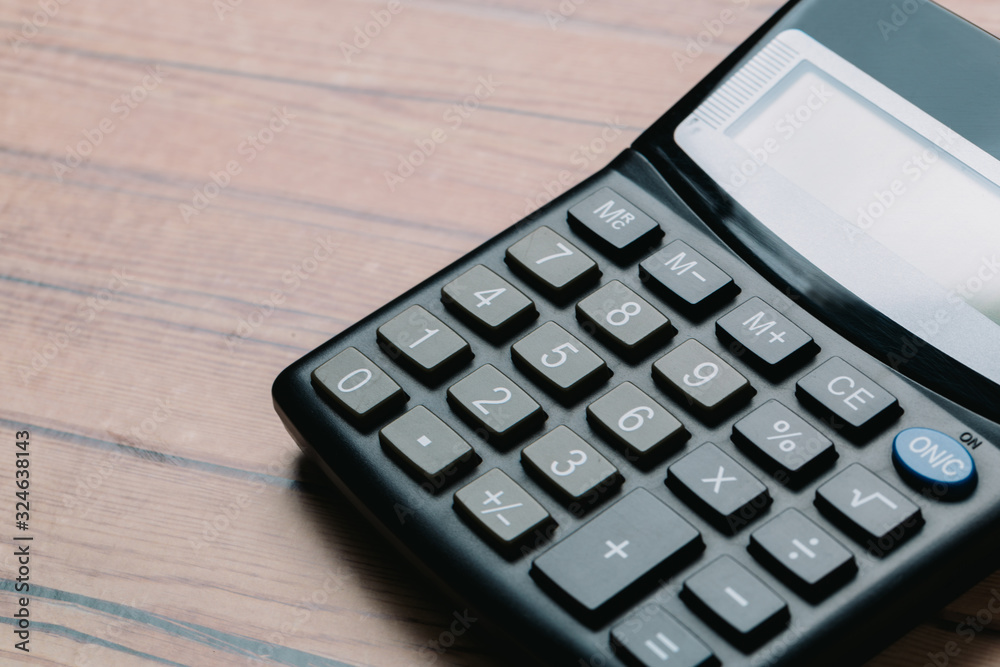 Modern calculator, Business and Finance accounting concept on wooden table Modern calculator, Business and Finance accounting concept on wooden table