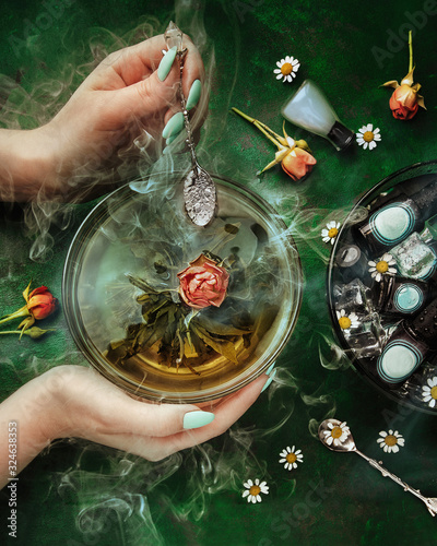 composition with woman's hands, red roses, smoke and nail polish