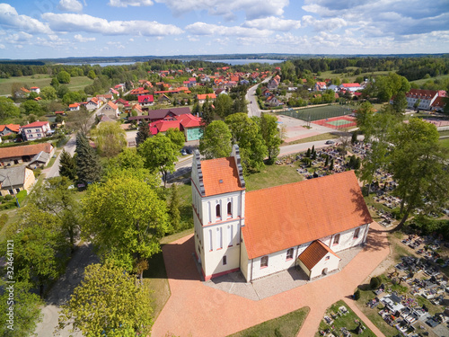 Aerial view of beautiful Assumption of Blessed Mary Virgin Church in Kruklanki, Poland (former Kruglanken, East Prussia) photo