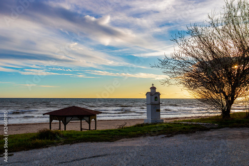 Shrine or kandilakia at the empty off-season winter Paralia Mesis beach in Rhodope prefecture, Greece at sunset photo