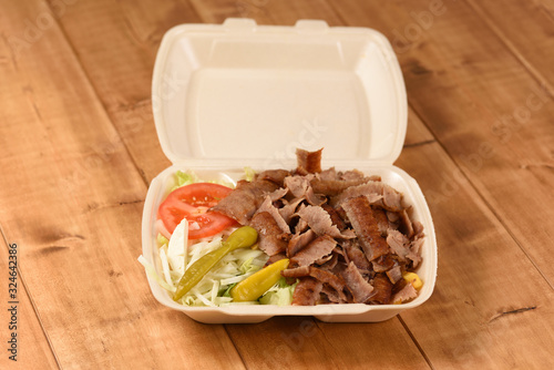 Delivered fast food doacner in a plastic box