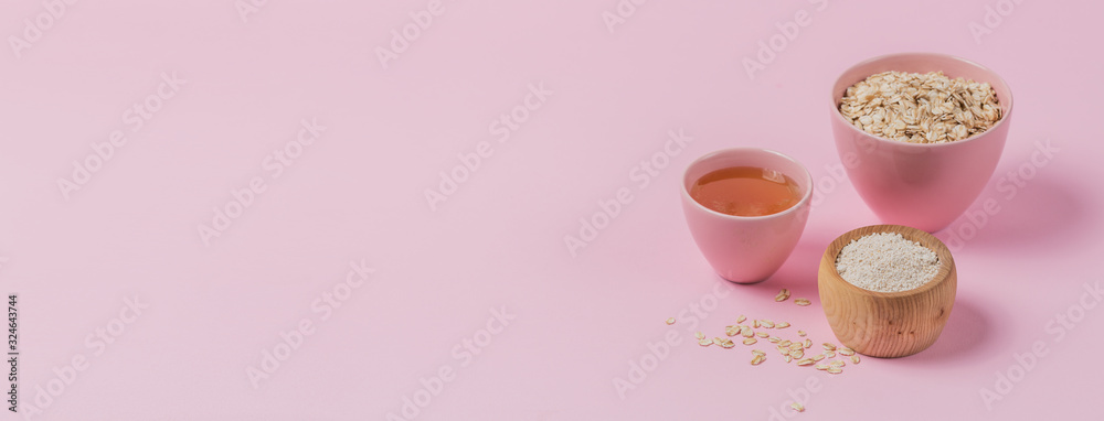 Bowl of dry oat flakes, oatmeal and honey on light background. Bowl of dry oat flakes, oatmeal and honey on light background.
