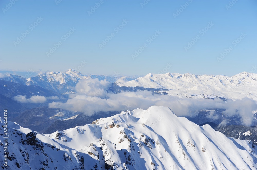 Winter scenery of French Alps with snow and clouds 