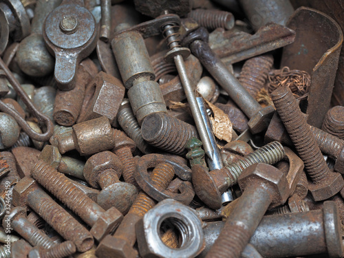 Dirty and rusty nuts and bolts close-up. Can be used as a template