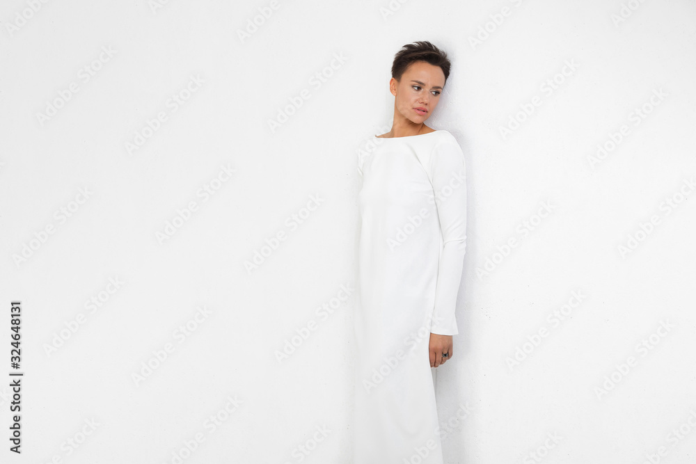 Beautiful young woman long white dress smiles Beautiful young woman long white dress smiles