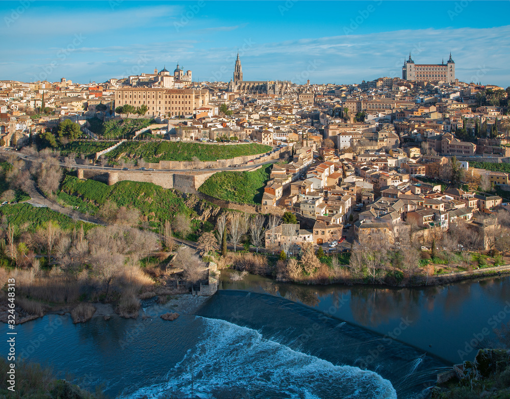 Toledo in morning light withe the Alcazar castle and cathedral over the Tajo river.