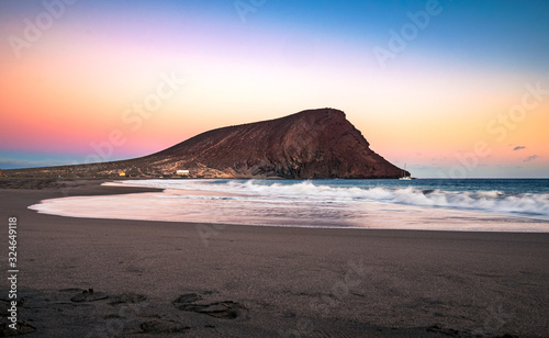 Colorful sky after sunset at La Tejita beach with the iconic 