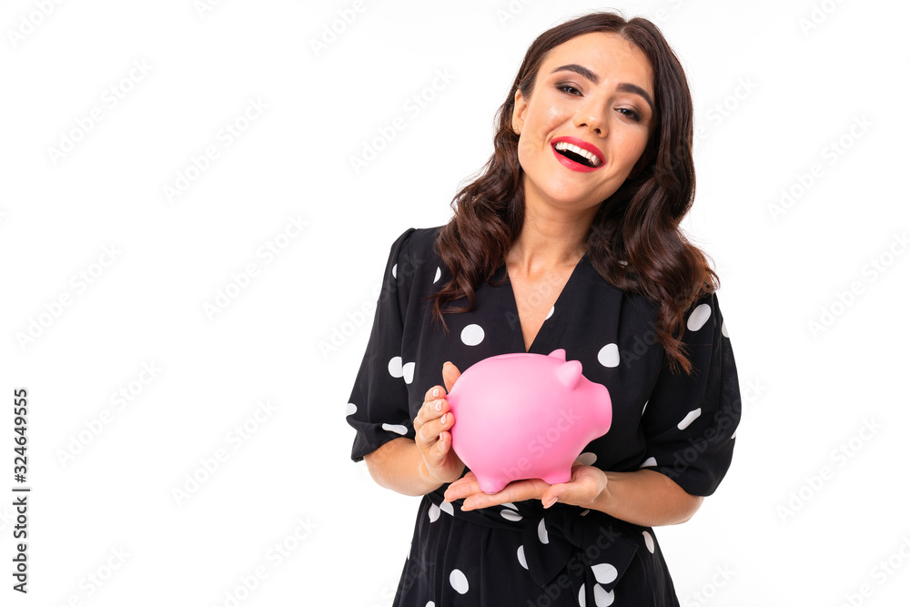 Portrait of nice caucasian girl holds a money box and thinks on white background Portrait of nice caucasian girl holds a money box and thinks on white background