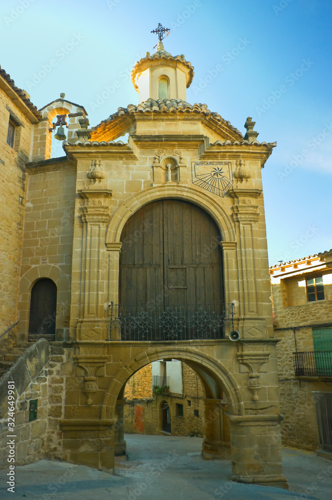 Street in the village of Calaceite Teruel Spain with arch-shaped door.